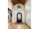 Grand foyer featuring soaring ceilings, a decorative chandelier, and wrought iron front door at 7635 E Sweetwater Ave, Scottsdale, AZ 85260