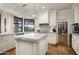 Bright kitchen features an island, marble countertops, custom cabinetry, and access to a wine cellar at 7635 E Sweetwater Ave, Scottsdale, AZ 85260