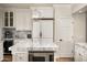 Well-appointed kitchen with a center island, marble countertops, and modern, white cabinetry at 7635 E Sweetwater Ave, Scottsdale, AZ 85260