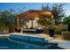 Inviting poolside pergola with comfortable seating and elegant lighting, perfect for entertaining at 7635 E Sweetwater Ave, Scottsdale, AZ 85260