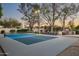 Well-lit pickleball court with seating, outdoor kitchen, and lush landscaping for recreation and leisure at 7635 E Sweetwater Ave, Scottsdale, AZ 85260