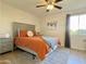 Cozy bedroom features neutral tones, a ceiling fan and a large window for natural light at 8055 E Thomas Rd # G101, Scottsdale, AZ 85251