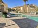 Inviting community pool with lounge chairs, umbrellas and lush landscaping offering a relaxing outdoor oasis at 8055 E Thomas Rd # G101, Scottsdale, AZ 85251