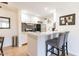 Charming kitchen with white cabinets, stainless steel appliances, and a breakfast bar with comfortable seating at 8055 E Thomas Rd # G101, Scottsdale, AZ 85251