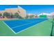 Community tennis court on a sunny day with a manicured green and blue playing surface at 8055 E Thomas Rd # G101, Scottsdale, AZ 85251