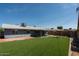 Large backyard with artificial turf, a covered patio, and a swing set, perfect for outdoor fun at 8115 E Cypress St, Scottsdale, AZ 85257