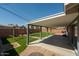 Spacious backyard with a large covered patio, artificial turf, and a swing set for outdoor entertainment at 8115 E Cypress St, Scottsdale, AZ 85257