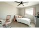 Inviting bedroom showcasing a single bed, desk area, plush carpeting, and soft pink accents at 8115 E Cypress St, Scottsdale, AZ 85257