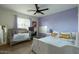 Bright bedroom featuring a crib, double bed with decorative pillows, and charming decor at 8115 E Cypress St, Scottsdale, AZ 85257