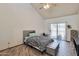 Vaulted bedroom featuring natural light, tile floors, a cozy bed, and sliding glass doors at 876 W El Monte Pl # 3, Chandler, AZ 85225
