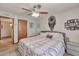 Bedroom featuring a comfortable queen-sized bed with patterned comforter, side tables, and a mirror at 876 W El Monte Pl # 3, Chandler, AZ 85225