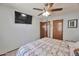 Comfortable bedroom featuring a ceiling fan, TV, and convenient access to other rooms at 876 W El Monte Pl # 3, Chandler, AZ 85225