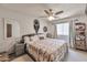 Cozy bedroom featuring a queen-sized bed with a patterned comforter, side tables, and a mirror at 876 W El Monte Pl # 3, Chandler, AZ 85225