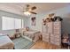Cozy bedroom with a ceiling fan, bright blue walls, and a matching rug and bed at 876 W El Monte Pl # 3, Chandler, AZ 85225