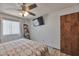 Inviting bedroom with a large window, TV, and wood-look flooring at 876 W El Monte Pl # 3, Chandler, AZ 85225