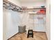 An organized walk-in closet with hanging rods and shelves for storing clothes and linens at 876 W El Monte Pl # 3, Chandler, AZ 85225