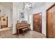 Inviting entryway with piano, tile floors, stylish lighting, and wooden front door at 876 W El Monte Pl # 3, Chandler, AZ 85225