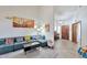 Cozy living room featuring tile floors, natural light, and access to the front entry at 876 W El Monte Pl # 3, Chandler, AZ 85225