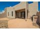 Backyard view of patio with stucco construction and desert landscaping at 8785 E Sandtrap Ct, Gold Canyon, AZ 85118