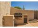 Outdoor kitchen with grill, storage, and stucco surround, perfect for outdoor cooking at 8785 E Sandtrap Ct, Gold Canyon, AZ 85118