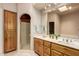 Elegant bathroom with double sinks, a glass door shower, a large mirror, and a linen closet at 8785 E Sandtrap Ct, Gold Canyon, AZ 85118