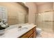 Bright bathroom with a tiled shower, oak cabinets, white countertops, and a large mirror at 8785 E Sandtrap Ct, Gold Canyon, AZ 85118