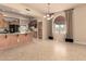 Dining room area featuring tile floors, an arched window, and access to a well-appointed kitchen, perfect for Gathering gatherings at 8785 E Sandtrap Ct, Gold Canyon, AZ 85118