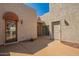Exterior view showcasing entry door, unique stucco architecture, and inviting courtyard space with desert landscaping at 8785 E Sandtrap Ct, Gold Canyon, AZ 85118