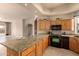 Open floor plan showcasing the kitchen island with custom cabinets, granite countertops, and appliances at 8785 E Sandtrap Ct, Gold Canyon, AZ 85118