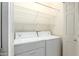 Laundry area with white washer and dryer, wire shelving, and a white door at 8785 E Sandtrap Ct, Gold Canyon, AZ 85118