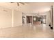 Open-concept living room flowing seamlessly into the kitchen with archway accents and tiled flooring at 8785 E Sandtrap Ct, Gold Canyon, AZ 85118
