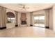 Bright living room featuring a cozy fireplace, tile flooring, and sliding glass doors to an enclosed patio, blending indoor-outdoor living at 8785 E Sandtrap Ct, Gold Canyon, AZ 85118