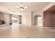 Spacious living room with a fireplace and tile flooring leading to the backyard at 8785 E Sandtrap Ct, Gold Canyon, AZ 85118