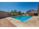 Community pool with patio furniture and drought resistant landscaping at 8785 E Sandtrap Ct, Gold Canyon, AZ 85118