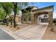 Exterior of home featuring stucco and stone, a porte cochere, and well-maintained landscaping at 9285 E Canyon Vw, Scottsdale, AZ 85255