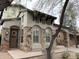 Charming front exterior features a stone facade, dark wood accents, and an arched entryway, framed by desert landscaping at 9285 E Canyon Vw, Scottsdale, AZ 85255