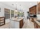 Bright kitchen featuring a center island with barstool seating, stainless steel appliances, and tile flooring at 9285 E Canyon Vw, Scottsdale, AZ 85255