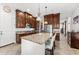 Bright kitchen with cherry wood cabinetry, granite countertops, a large center island, and stainless steel appliances at 9285 E Canyon Vw, Scottsdale, AZ 85255