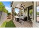 Cozy covered patio with stone columns, a ceiling fan, and comfortable seating, ideal for outdoor entertaining at 9285 E Canyon Vw, Scottsdale, AZ 85255
