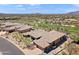 Stunning aerial shot highlights a desert landscape home with a tile roof near a green golf course at 9620 E Roadrunner Dr, Scottsdale, AZ 85262