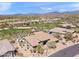 Expansive aerial view of the property showcasing the pool, landscaping, and surrounding community near the golf course at 9620 E Roadrunner Dr, Scottsdale, AZ 85262