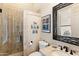 Bathroom with glass enclosed tile shower, toilet, and vanity with framed mirror, offering a clean design at 9620 E Roadrunner Dr, Scottsdale, AZ 85262