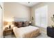 Bedroom with a bed featuring an upholstered headboard, side tables with lamps, and plantation shutters at 9620 E Roadrunner Dr, Scottsdale, AZ 85262