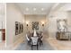 Elegant dining room with large table, decorative wall art, and custom lighting at 9620 E Roadrunner Dr, Scottsdale, AZ 85262
