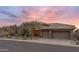 Stunning desert home with a three-car garage, stone accents, and beautiful desert landscaping at 9620 E Roadrunner Dr, Scottsdale, AZ 85262