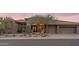 A luxury desert home showcases beautiful stone accents, a tile roof, and a meticulously landscaped front yard at 9620 E Roadrunner Dr, Scottsdale, AZ 85262