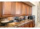 Gourmet kitchen with custom cabinets, stone backsplash, and granite countertops at 9620 E Roadrunner Dr, Scottsdale, AZ 85262