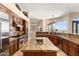 Spacious kitchen with a large island, stainless steel appliances, and brown cabinets with granite countertops at 9620 E Roadrunner Dr, Scottsdale, AZ 85262