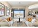 Elegant living room featuring dual sofas with a view of the pool through folding glass doors at 9620 E Roadrunner Dr, Scottsdale, AZ 85262