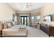 Serene primary bedroom with a ceiling fan, desert views, neutral colors, and luxurious furnishings at 9620 E Roadrunner Dr, Scottsdale, AZ 85262